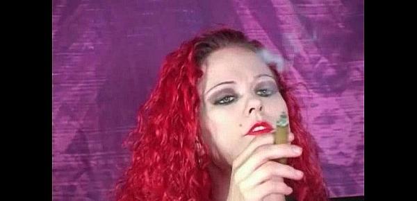  Redhead Melissa smokes a cigar while teasing us